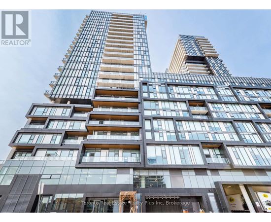 A tall building with many windows and balconies, with a sign that reads "REALTOR®".