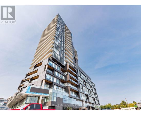 A tall building with a glass facade and a logo of a realtor on the bottom left.