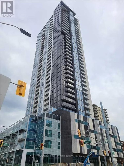 A tall building under construction with a crane in front of it.