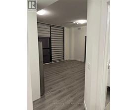A room with a sliding door and wood flooring.