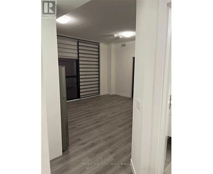A room with a sliding door and wood flooring.