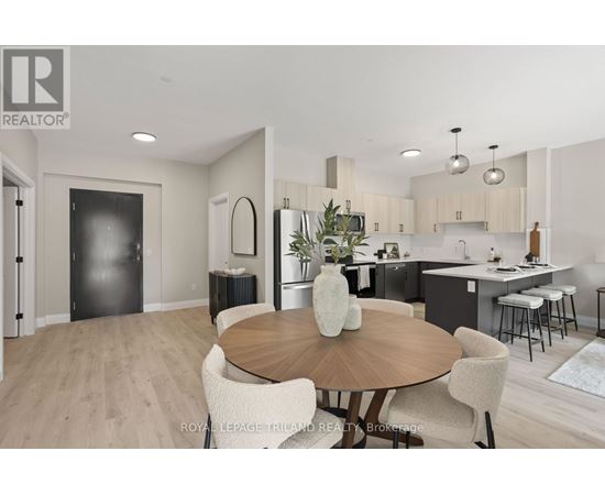A modern kitchen and dining room with a wooden table and chairs.