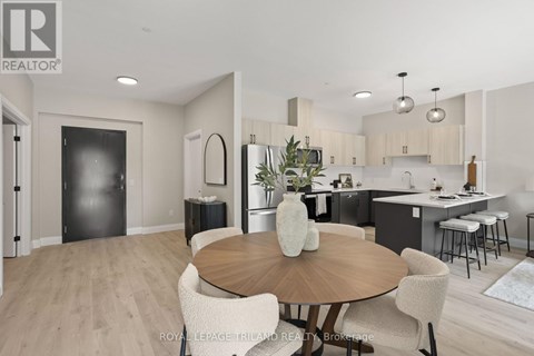 A modern kitchen and dining room with a wooden table and chairs.
