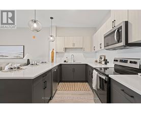 A modern kitchen with a white countertop and black cabinets.