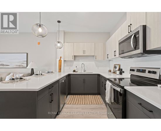 A modern kitchen with a white countertop and black cabinets.