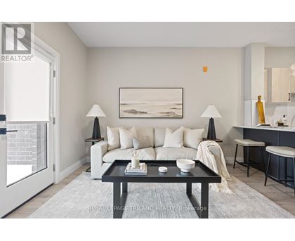 A modern living room with a white sofa, a black coffee table, and a painting on the wall.