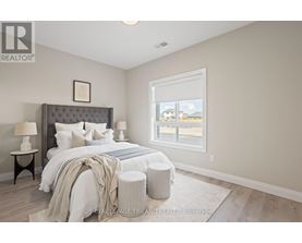 A bedroom with a large bed and a window overlooking a street.