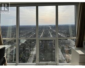 A view from a high-rise window looking out at a cityscape.