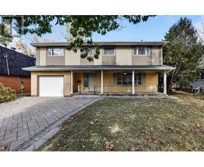 A house with a grey roof and a white garage door.