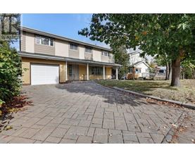 A residential building with a driveway in front.
