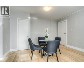 A dining room with a table and chairs.
