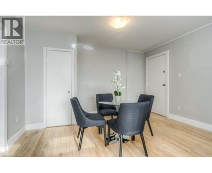A dining room with a table and chairs.