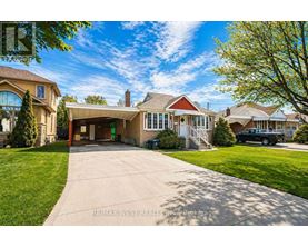 A large house with a driveway in front of it.