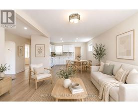 A well-lit living room with a couch, chairs, and a coffee table.