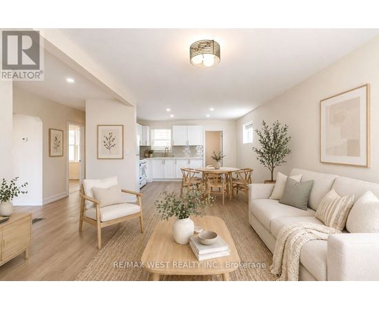 A well-lit living room with a couch, chairs, and a coffee table.
