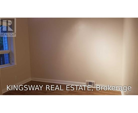 A Kingsway Real Estate Brokerage logo is displayed on a wall.