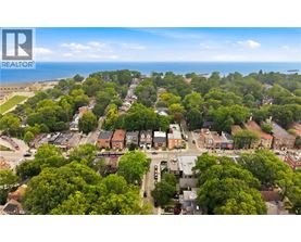 A bird's eye view of a residential area with houses surrounded by trees.