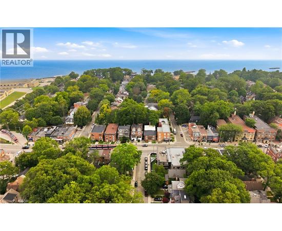 A bird's eye view of a residential area with houses surrounded by trees.