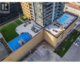 A swimming pool is located on the roof of a building.