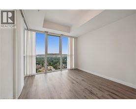 A spacious room with a view of the city through large windows.