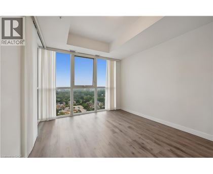 A spacious room with a view of the city through large windows.