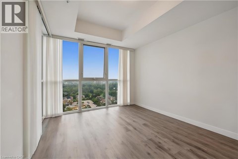 A spacious room with a view of the city through large windows.