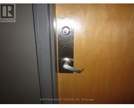 A door with a silver handle and a number 512 on it.