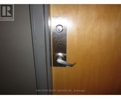 A door with a silver handle and a number 512 on it.