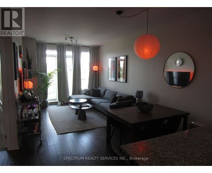 A living room with a couch, a coffee table, and a mirror.