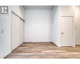 A room with a wooden floor and a white door.