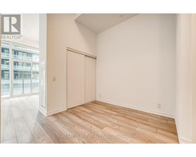 A room with wooden flooring and a sliding door.
