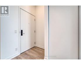 A white door with a black handle is in a room with white walls.