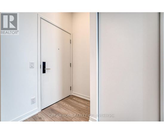 A white door with a black handle is in a room with white walls.