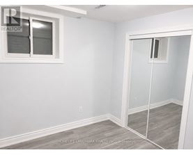 A room with a white wall and a sliding glass door.