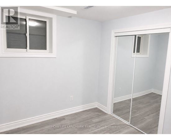 A room with a white wall and a sliding glass door.