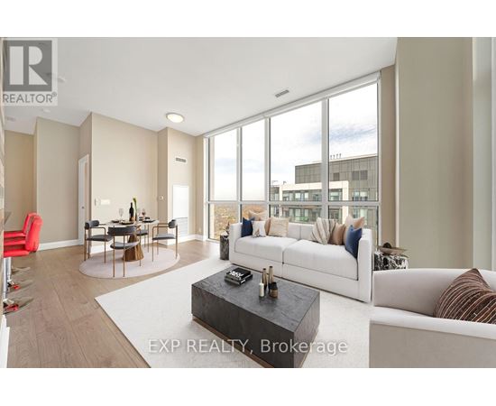 A living room with a white couch and a coffee table.