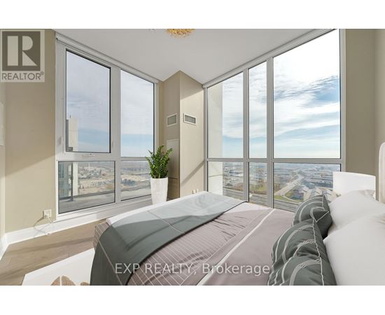 A bedroom with a large bed and a view of the city through the windows.
