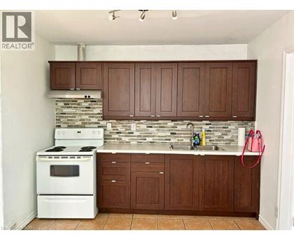 A kitchen with white appliances and brown cabinets.