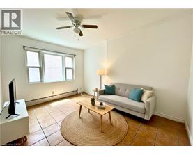 A living room with a couch, a coffee table, and a television.