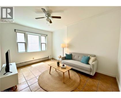 A living room with a couch, a coffee table, and a television.