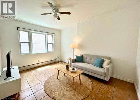 A living room with a couch, a coffee table, and a television.