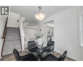 A dining room with a glass table and chairs.