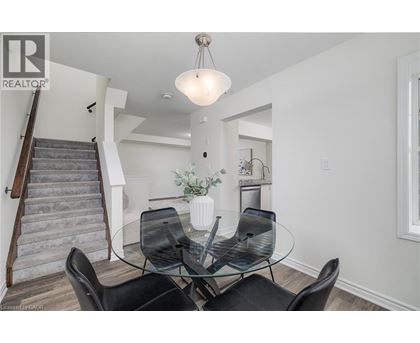 A dining room with a glass table and chairs.