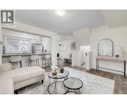A living room with a white couch and a glass table.