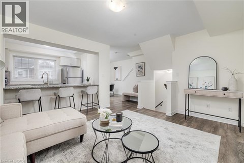 A living room with a white couch and a glass table.