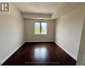 A room with a window and wooden floors.