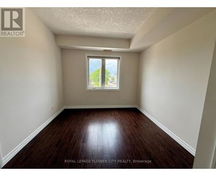 A room with a window and wooden floors.