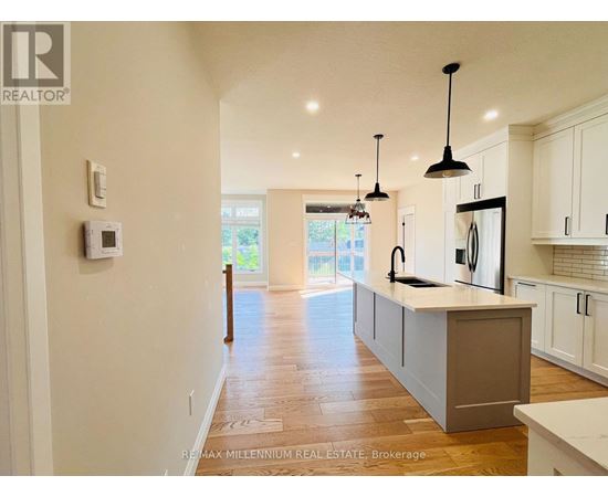 A modern kitchen with white cabinets and a central island.