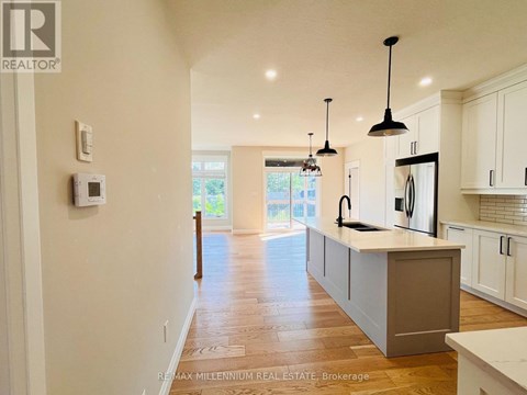 A modern kitchen with white cabinets and a central island.