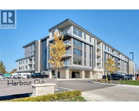 A modern building named Harbour Club is shown with a clear blue sky in the background.